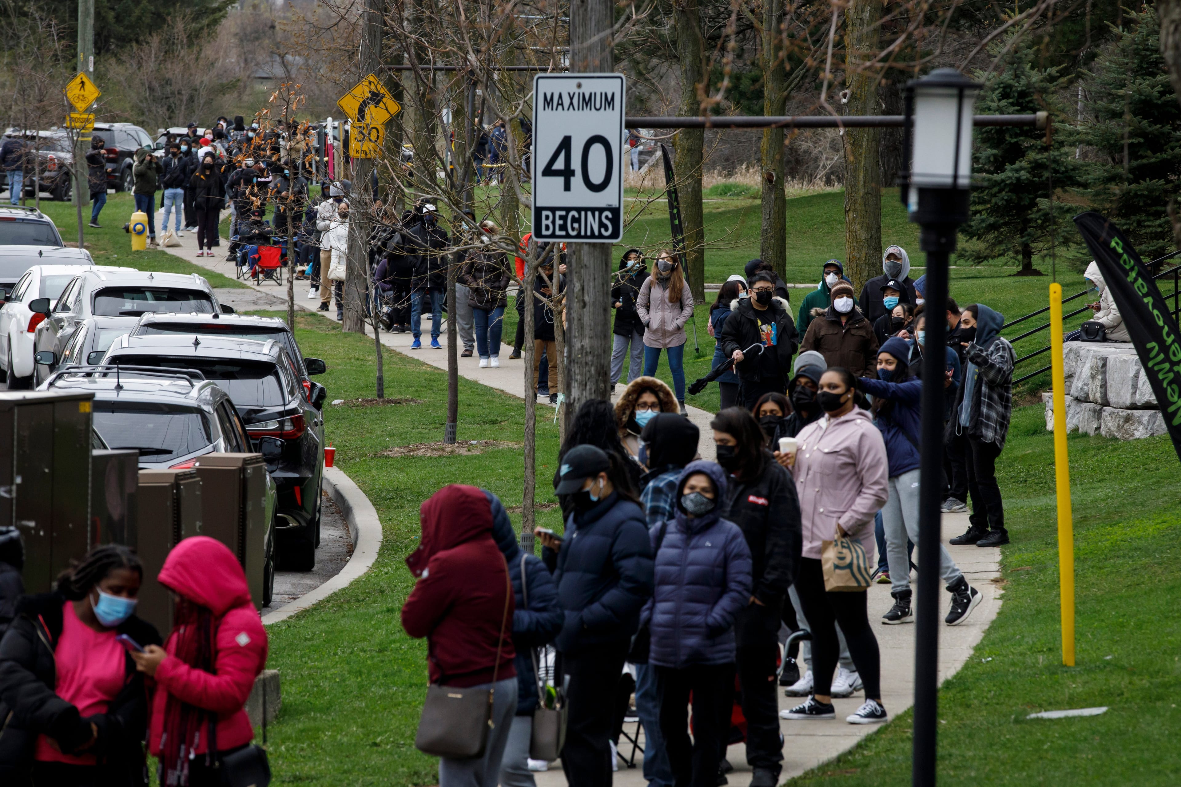 Residents of Toronto's Jane and Finch neighbourhood, in the M3N postal code, line up at a pop-up COVID-19 vaccine clinic on Saturday, April 17, 2021. THE CANADIAN PRESS/Cole Burston