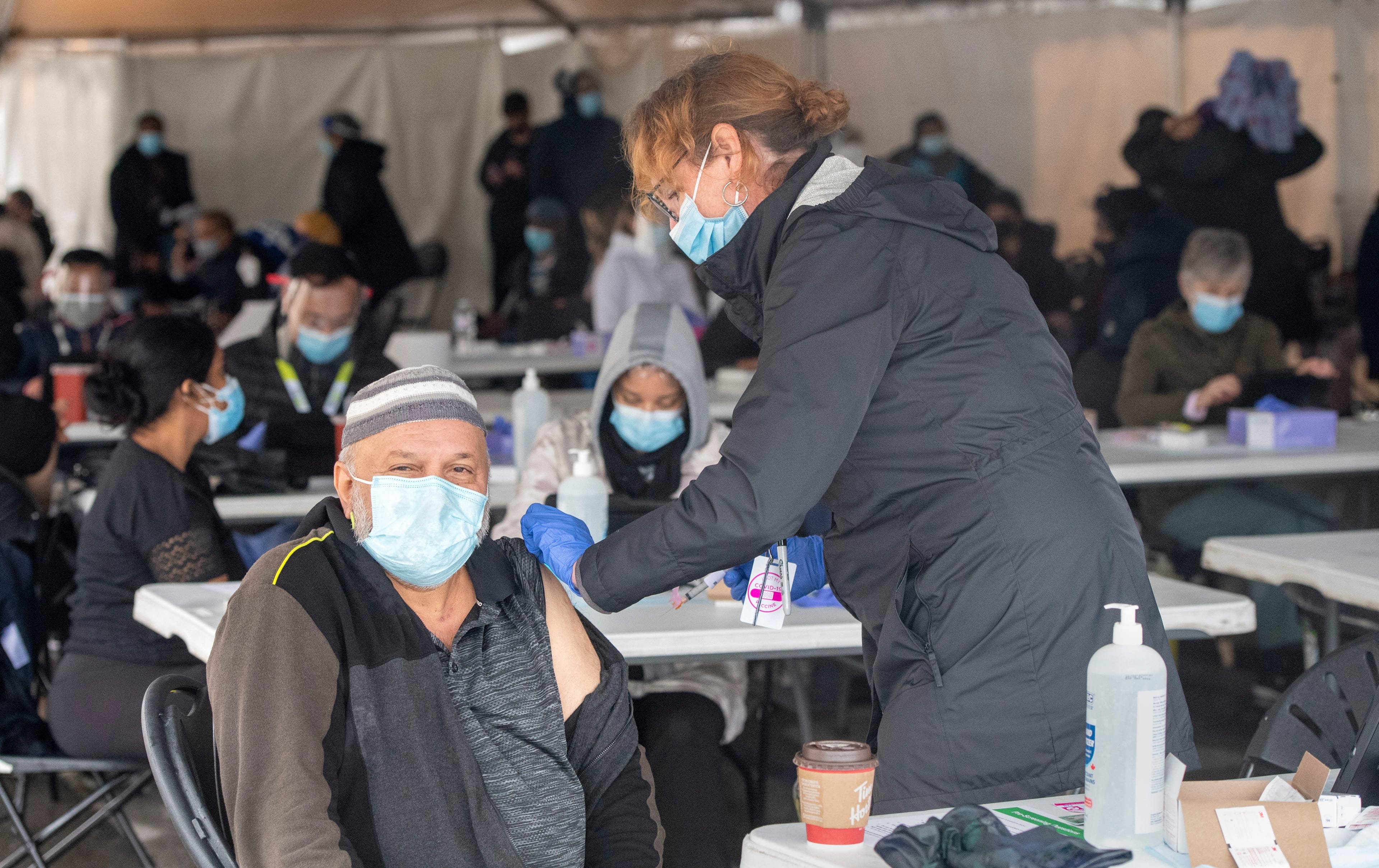 A nurse administers a COVID-19 vaccine at a pop-up clinic at the Masjid Darus Salaam in the Thorncliffe Park neighbourhood in Toronto on Sunday, April 11, 2021. THE CANADIAN PRESS/Frank Gunn