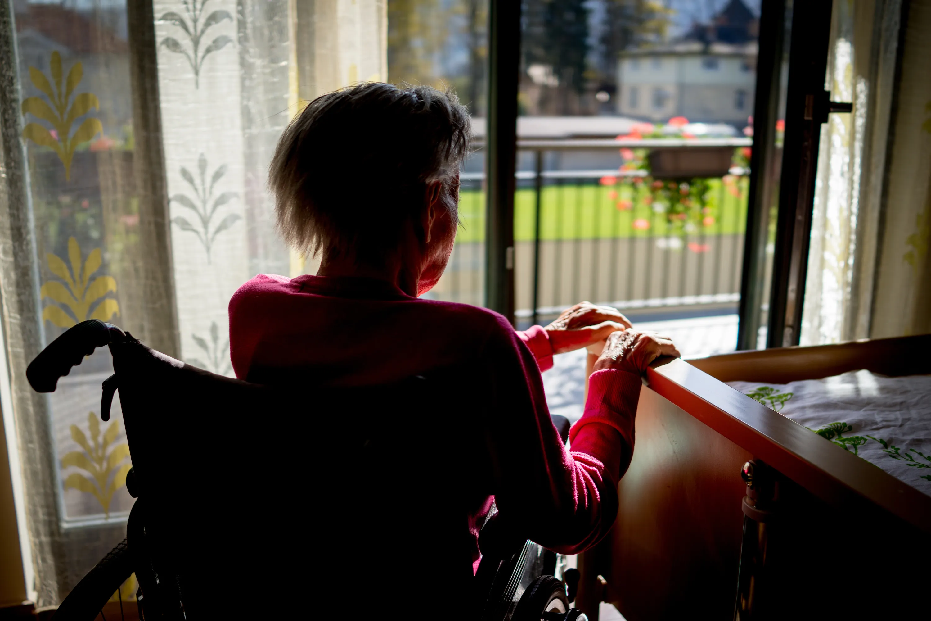 senior woman in wheelchair at home in living room (Getty Images)