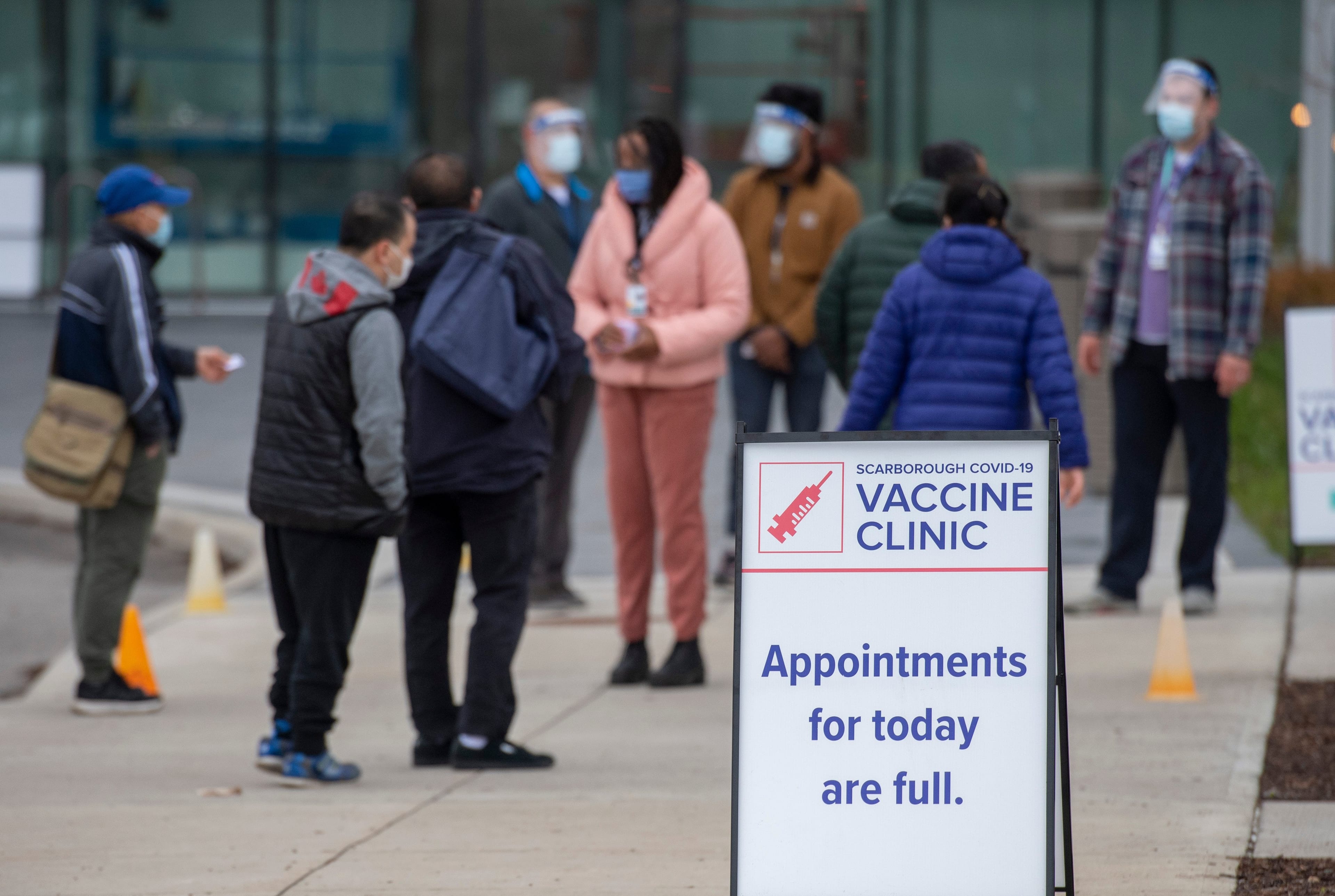 Visitors arrive at a pop up COVID-19 vaccine clinic at David and Mary Thomson high school in Toronto on Thursday, April 29, 2021. Hundreds of people lined up through the night in the hard hit community. THE CANADIAN PRESS/Frank Gunn