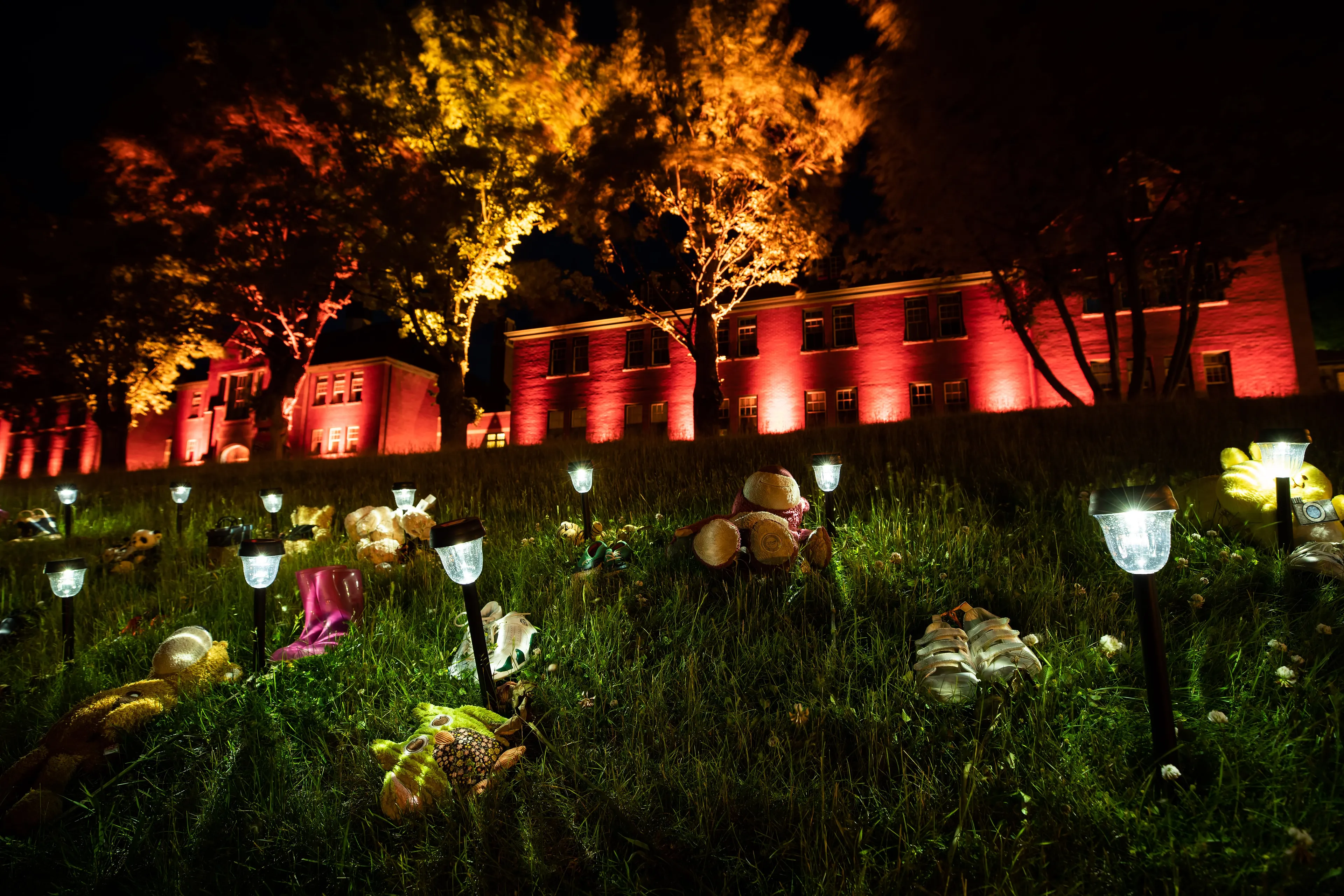 Shoes are placed on the lawn outside the former Kamloops Indian Residential School on June 4, 2021 (Darryl Dyck/CP)