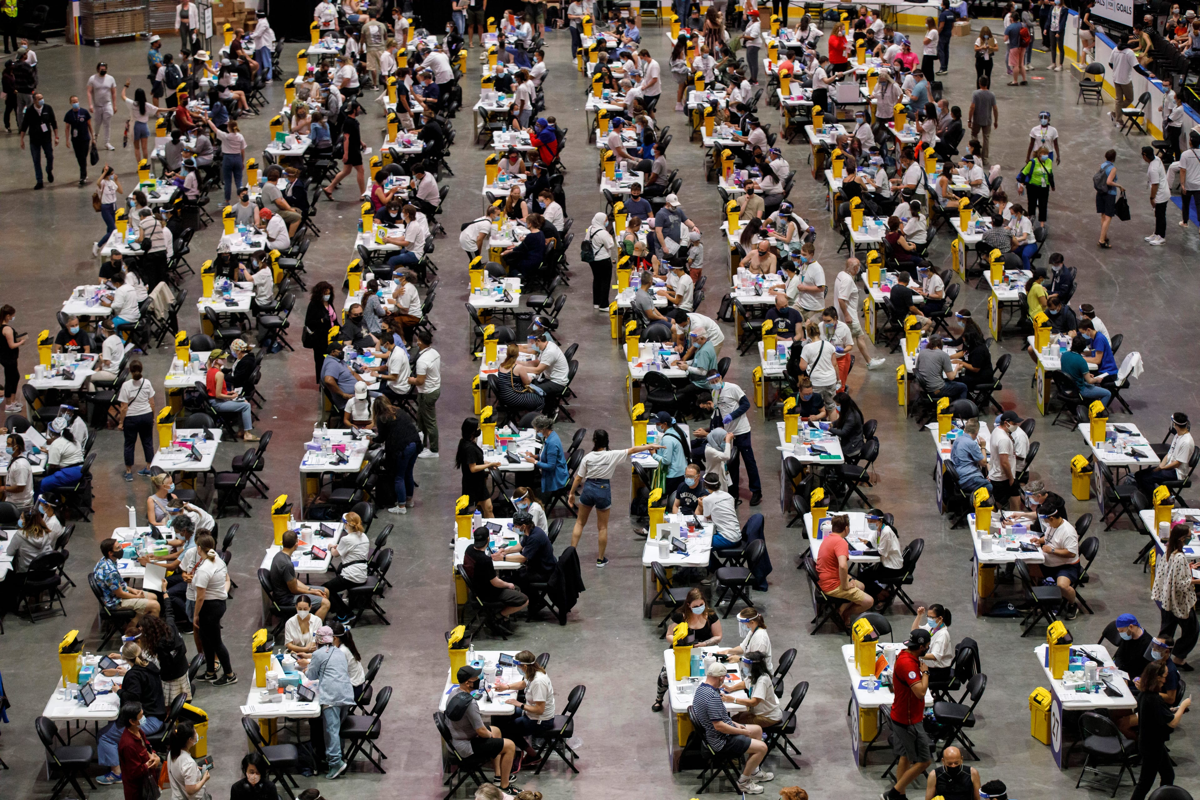 People receive a dose of the COVID-19 vaccine at a mass vaccination clinic at Scotiabank Arena in Toronto on Sunday, June 27, 2021. THE CANADIAN PRESS/Cole Burston