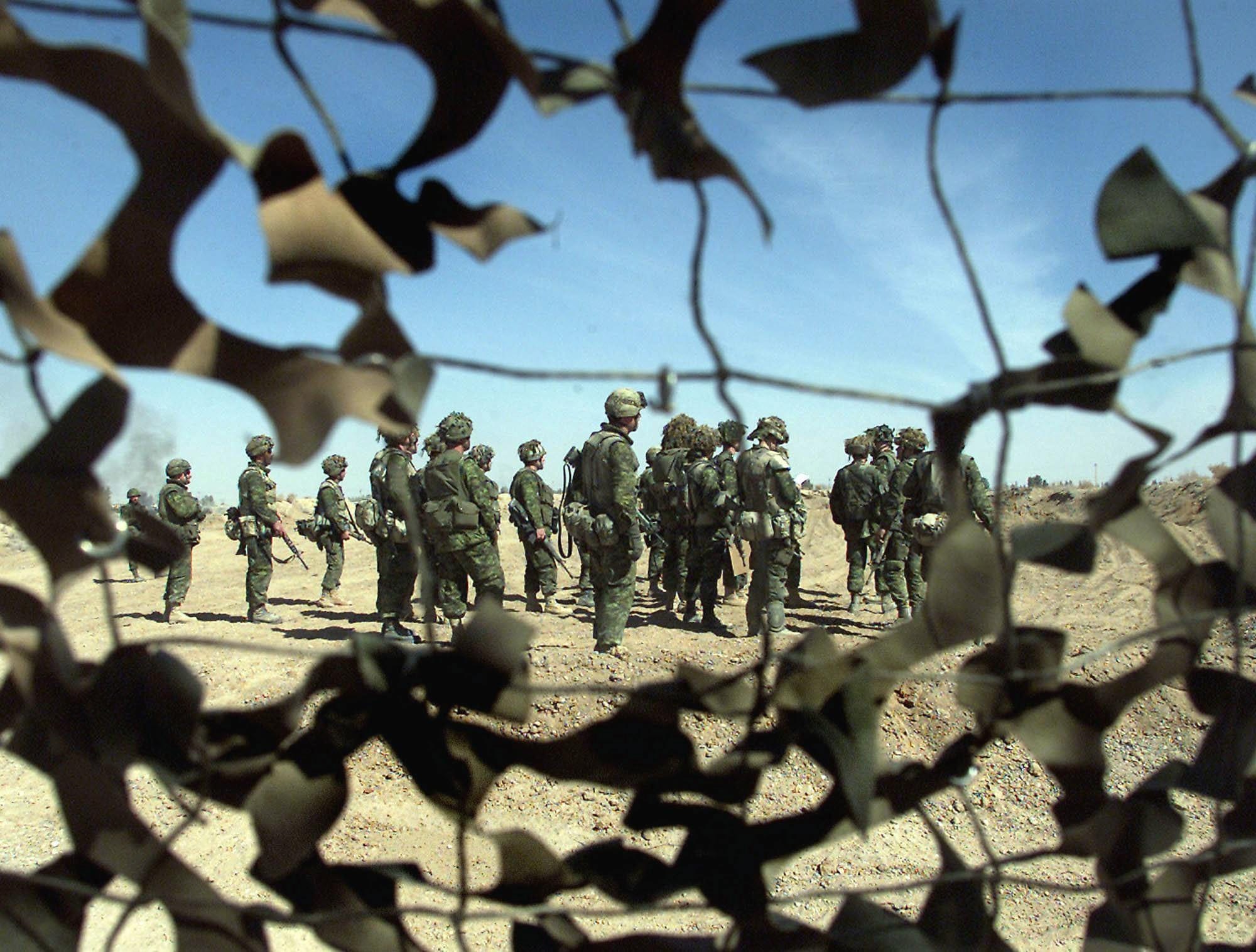 Canadian soldiers survey defensive positions they will eventually take over from the U.S. 101st Airborne at the airbase in Kandahar, Afghanistan on Feb. 10, 2002 (Kevin Frayer/CP)