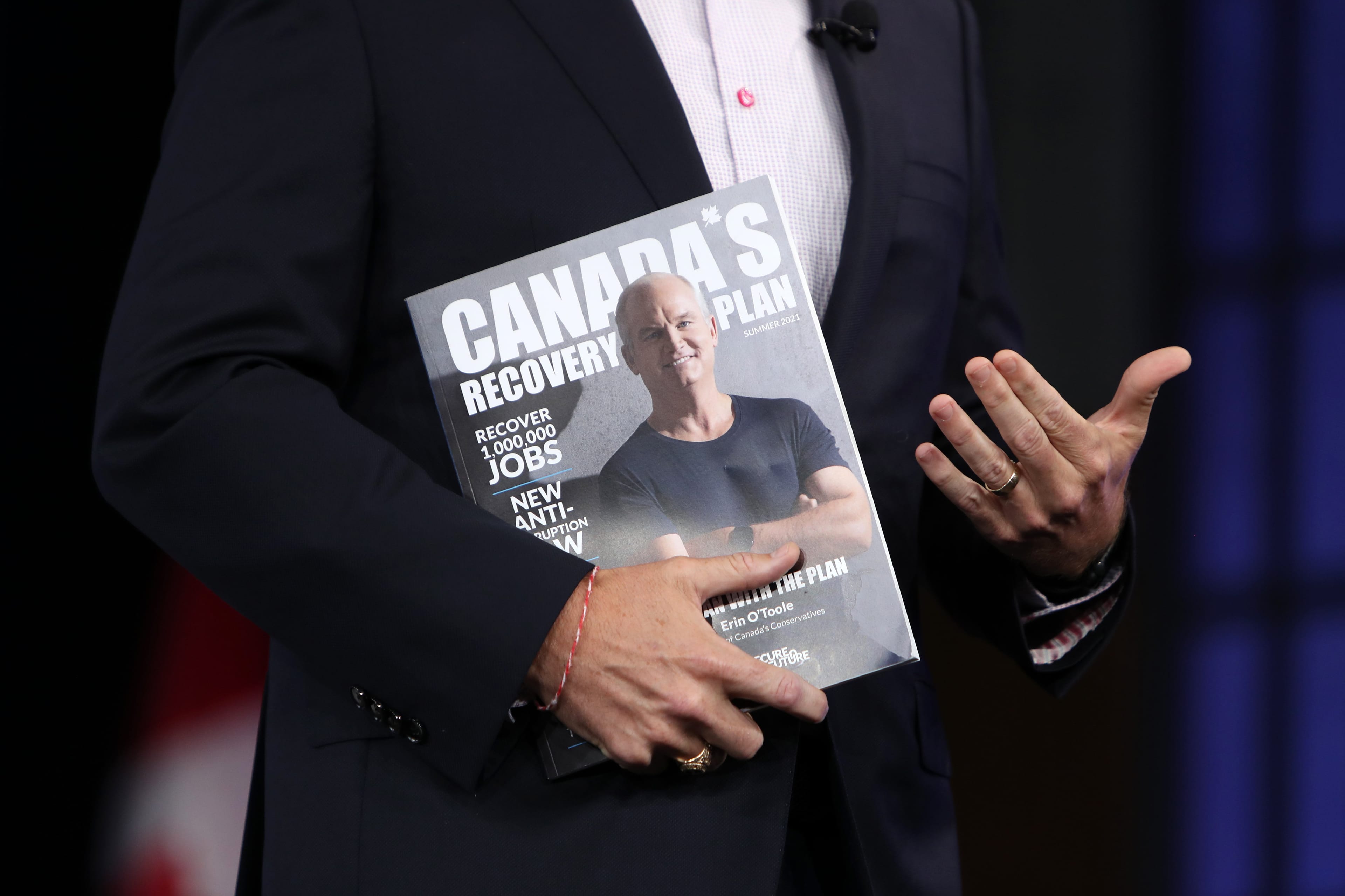 Erin O'Toole, leader of Canada's Conservative Party, holds a magazine featuring his recovery plan during a campaign event in Ottawa, Ontario, Canada, on Monday, Aug. 16, 2021. Prime Minister Justin Trudeau called an election for Sept. 20, seeking to retake a majority in Canadas parliament on the back of polls showing many voters approve of his governments handling of the coronavirus pandemic. Photographer: David Kawai/Bloomberg via Getty Images