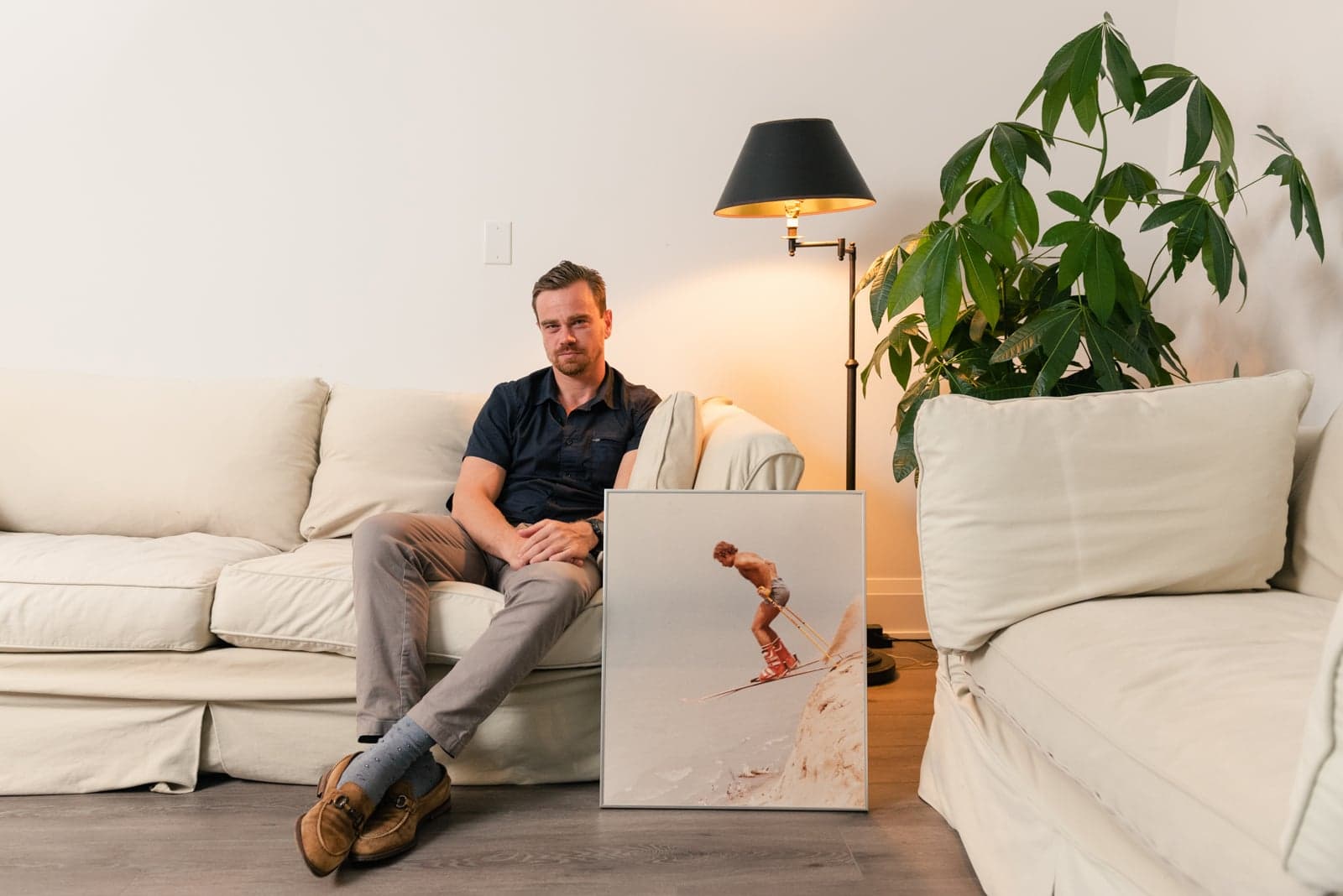 Brennan Basnicki with a photograph of his father, Ken, sand skiing.(Photograph by Lucy Lu)