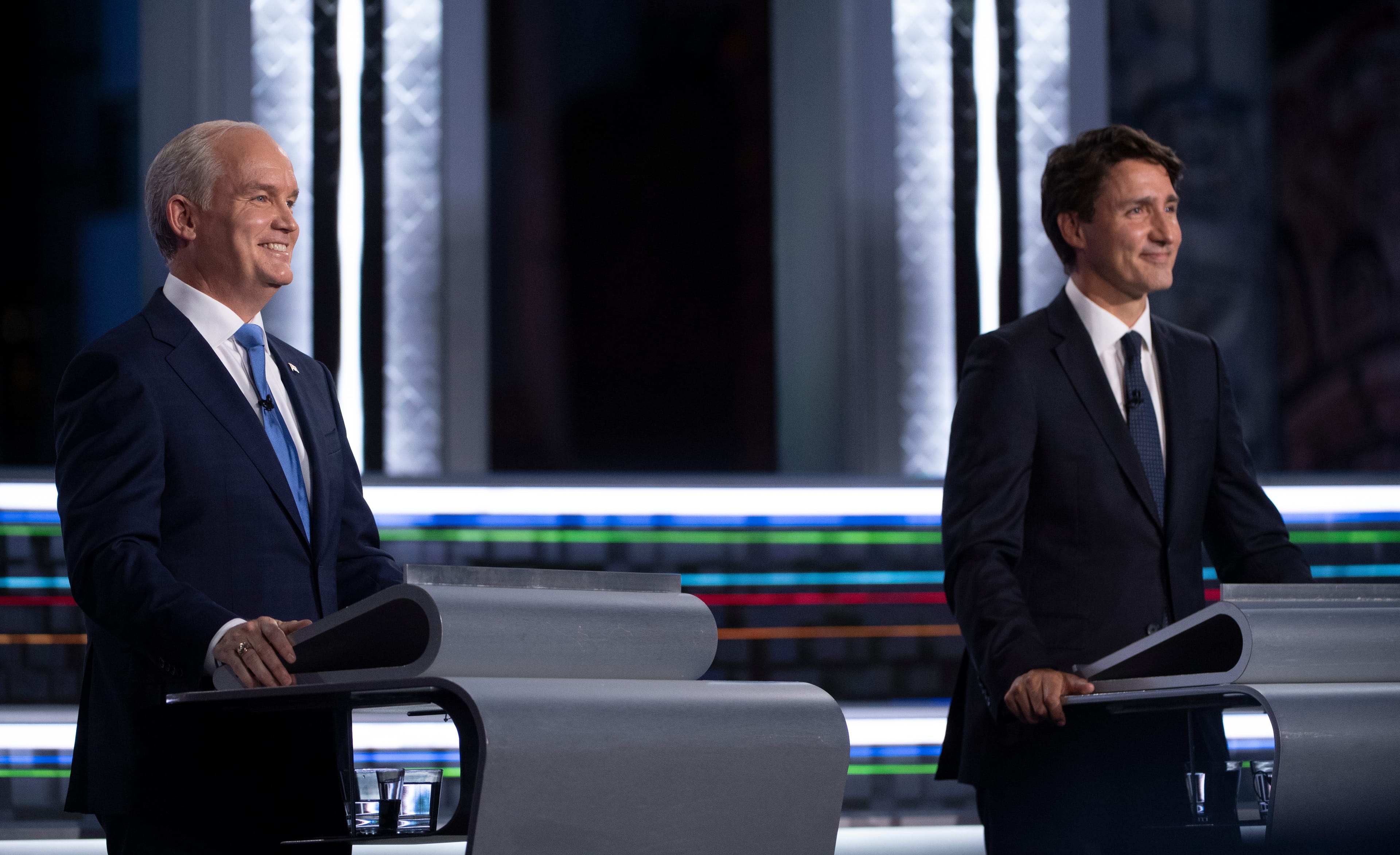 O'Toole and Trudeau smile during the federal election French-language leaders debate on Sept. 8, 2021 in Gatineau, Que. (Justin Tang/CP)