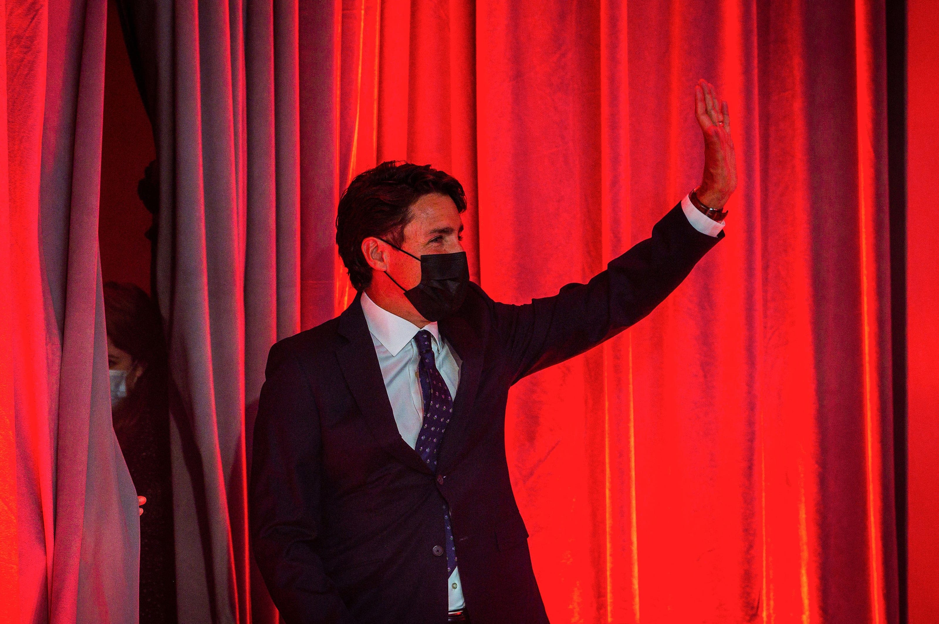 Canadian Prime Minister Justin Trudeau waves as he arrives to deliver his victory speech after snap parliamentary elections at the Queen Elizabeth Hotel in Montreal, Quebec, early on September 21, 2021. - Canadians returned Liberal Prime Minister Justin Trudeau to power on September 20 in hotly contested elections against a rookie conservative leader, according to projections by television networks. (Andrej Ivanov/AFP/Getty Images)