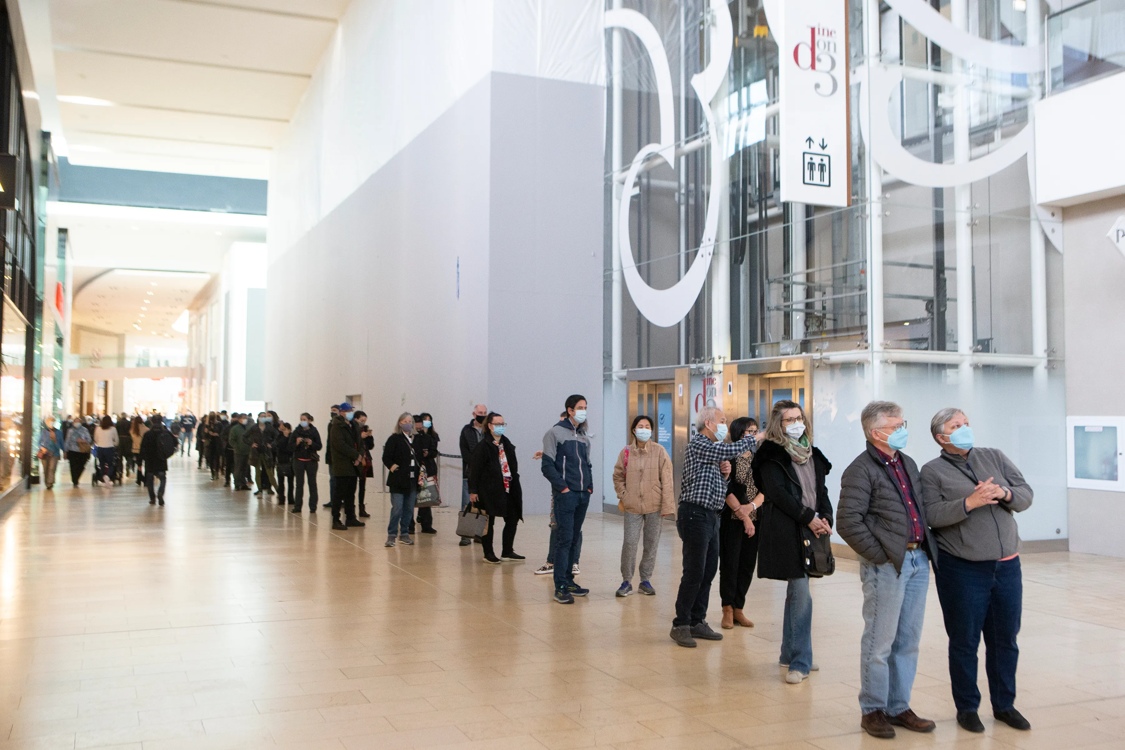 A lengthy queue snakes though Toronto's Yorkdale Mall as people wait to receive free COVID-19 rapid antigen test kits at a pop-up site at the shopping complex. (Chris Young/CP)