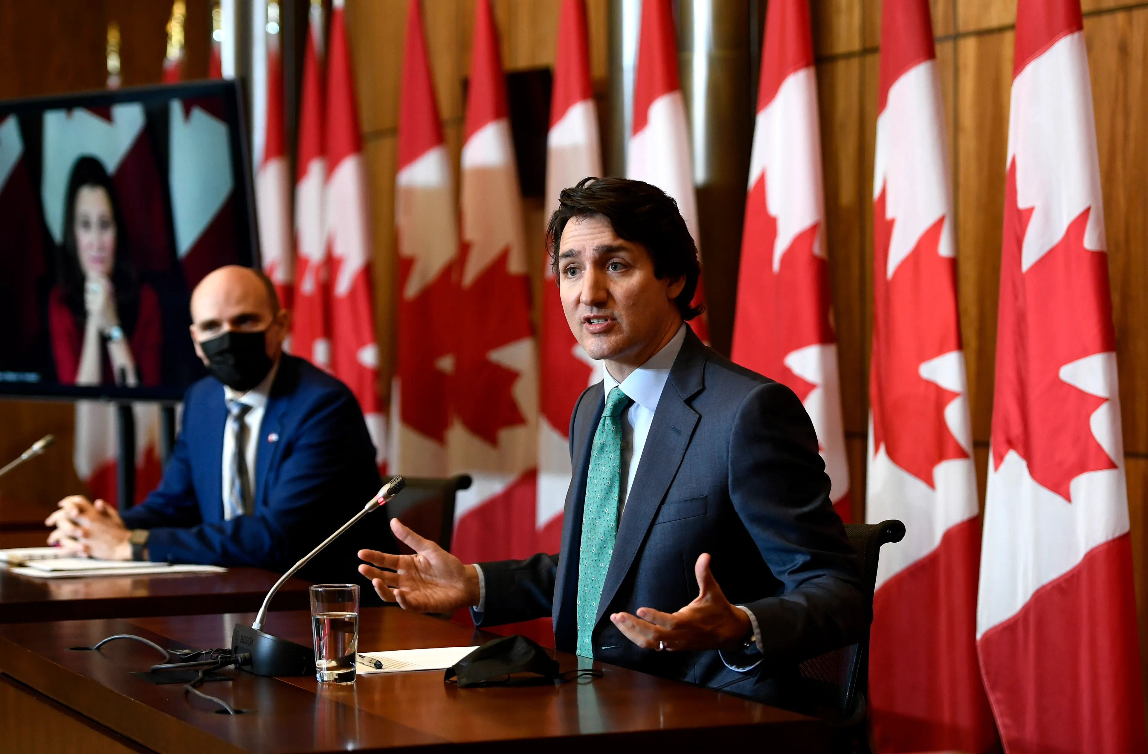 Trudeau speaks as Minister of Health Jean-Yves Duclos and Deputy Prime Minister and Minister of Finance Chrystia Freeland, seen via videoconference, participate in a news conference on the COVID-19 pandemic in Ottawa, Jan. 5, 2022. (Justin Tang/The Canadian Press)