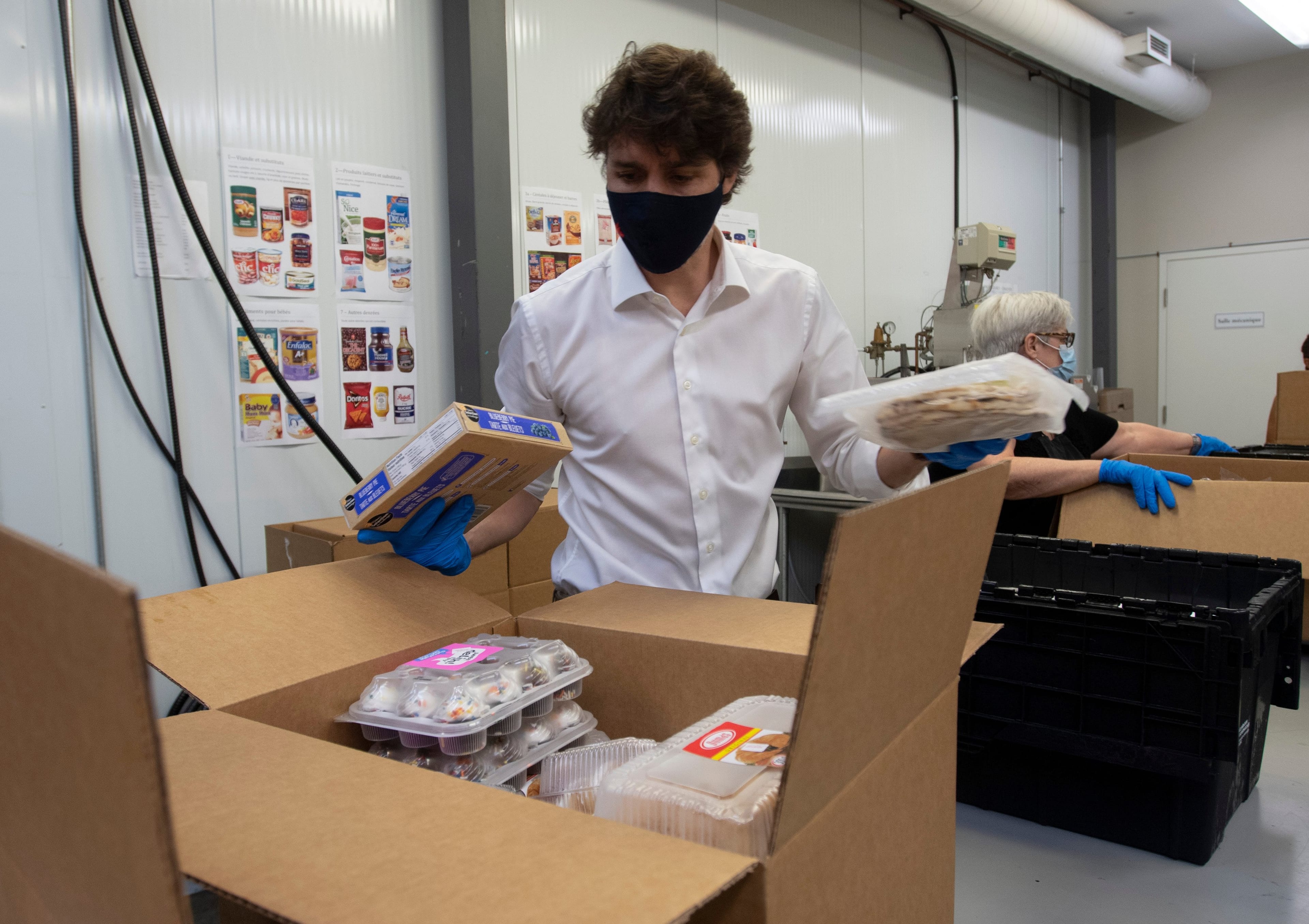 Trudeau in 2020, helping staff at a Gatineau, Que. food bank. (Adrian Wyld/CP)