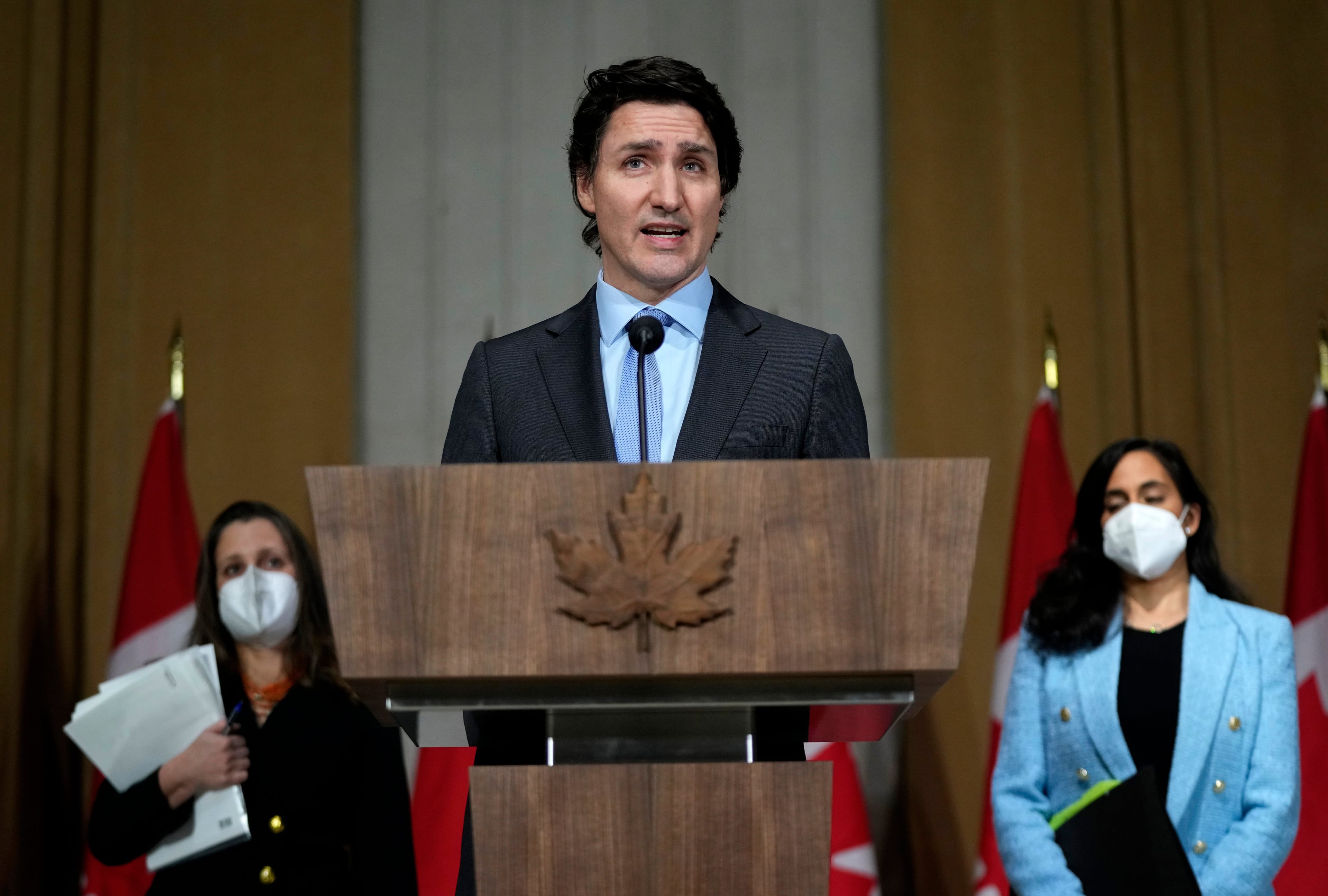 Prime Minister Justin Trudeau is joined by Deputy Prime Minister and Minister of Finance Chrystia Freeland, left, Minister of National Defence Anita Anand, as he speaks during a media availability on the situation in Ukraine, in Ottawa, Feb. 22, 2022. (Justin Tang/The Canadian Press)