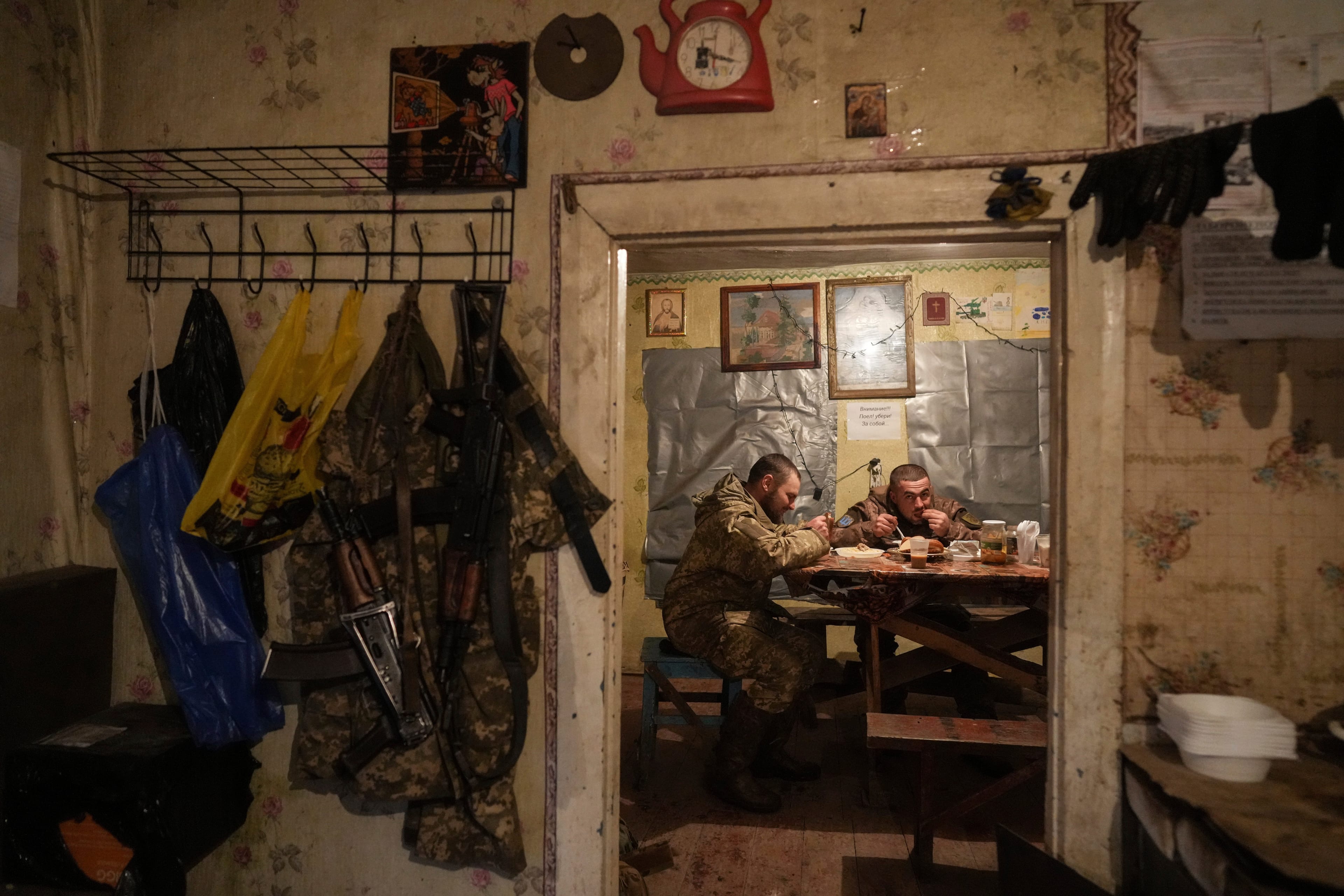 Ukrainian servicemen eating dinner last week after their duty at the frontline near Svitlodarsk, in eastern Ukraine. (Evgeniy Maloletka/AP)