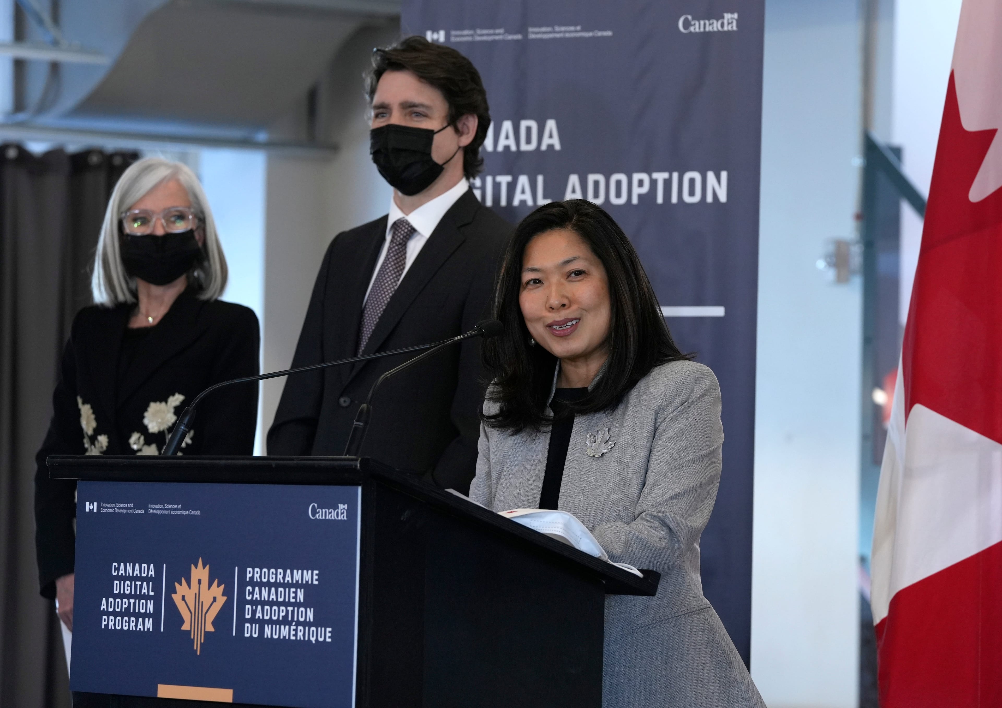 Trudeau listens as Ng speaks at a news conference on the Canadian Digital Adoption Program at Bayview Yards in Ottawa, on March 3, 2022 (Justin Tang/CP)