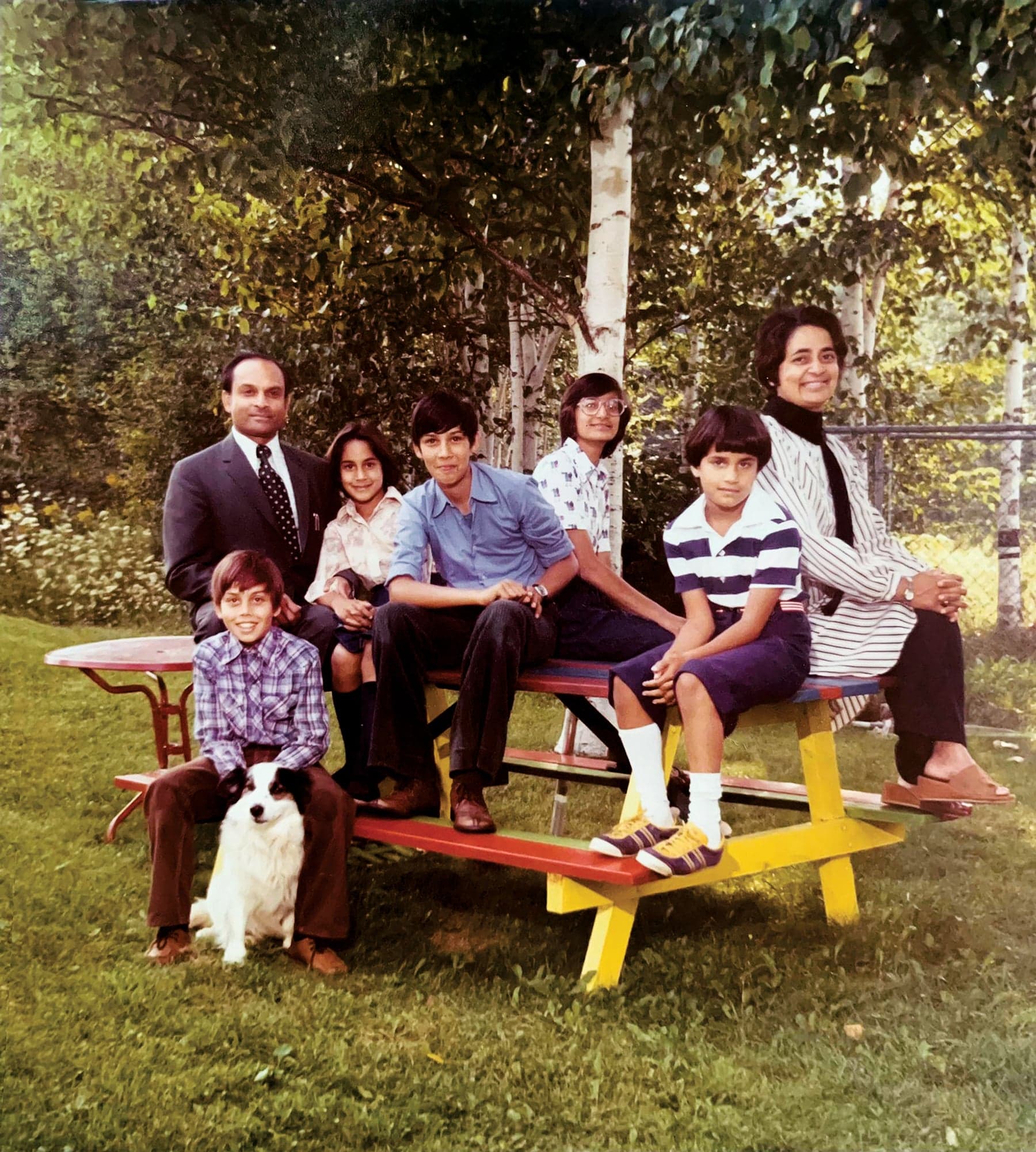 Anand, shown here with her parents and cousins in the backyard of her childhood home, grew up in Kentville, Nova Scotia. She appears third from left, seated next to her father.