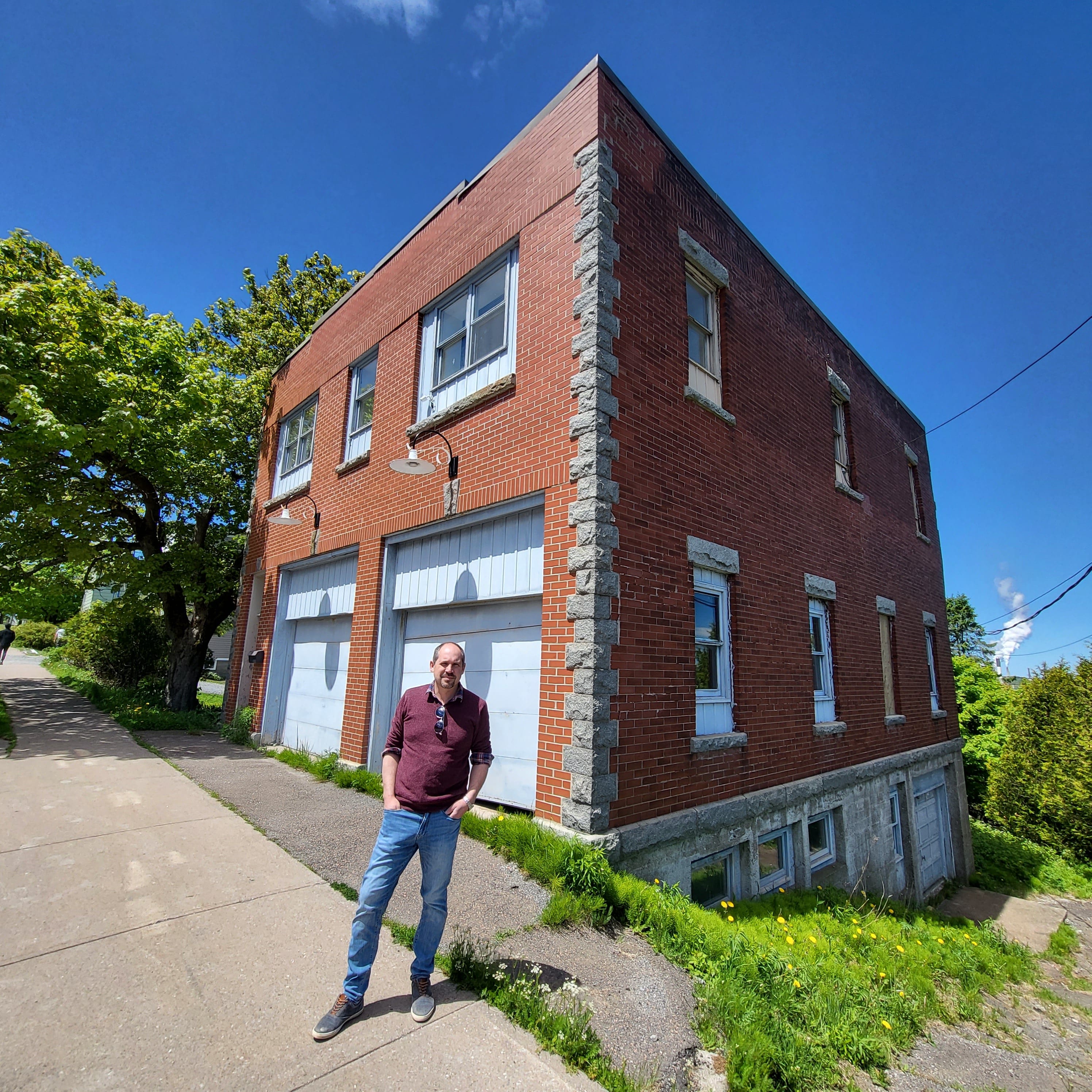 Jake Palmer stands in front of the historic fire station he plans to transform into a luxury home (Photos courtesy Rob Csernyik and Jake Palmer)