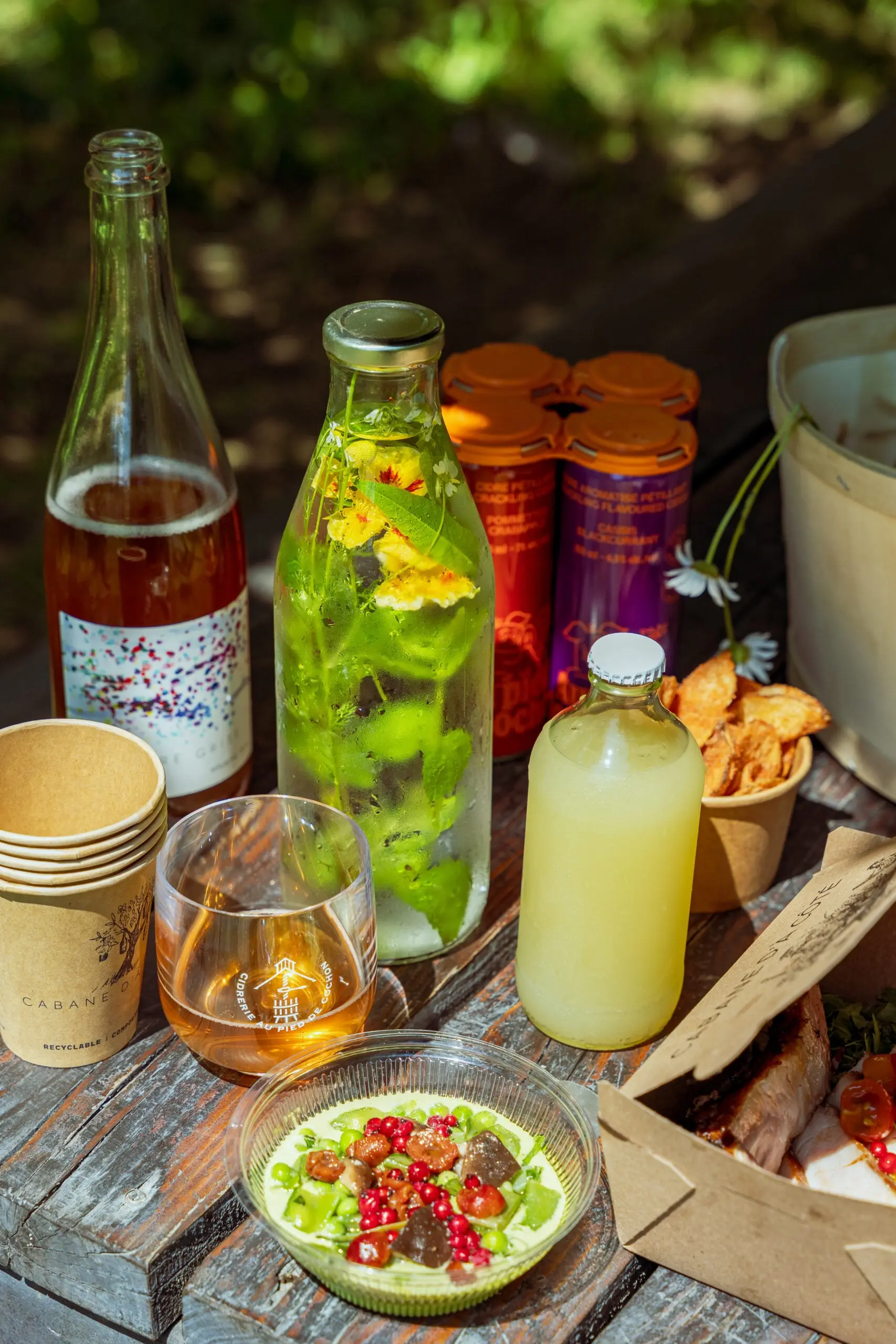 A spread of picnic foods in glass containers