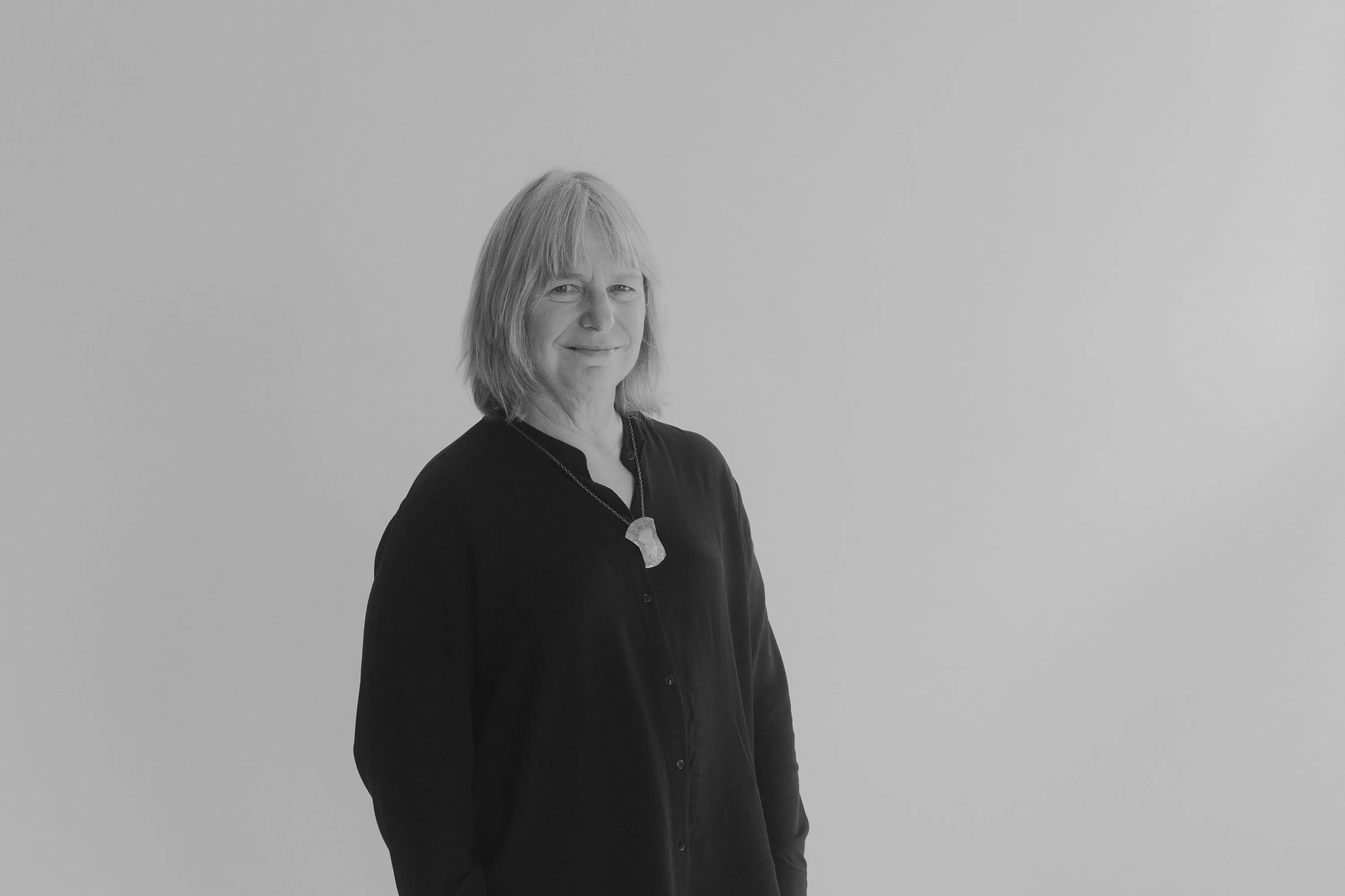 Suzanne Simard is looking at the camara, photographed in black and white.