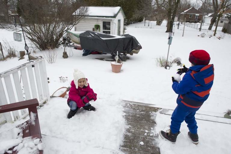 <p>Newly landed Syrian refugees  Dalya and Ibrahim Alkhalaf play with snow for the first time outside their Peterborough home.  (Photograph by Cole Garside)</p>
