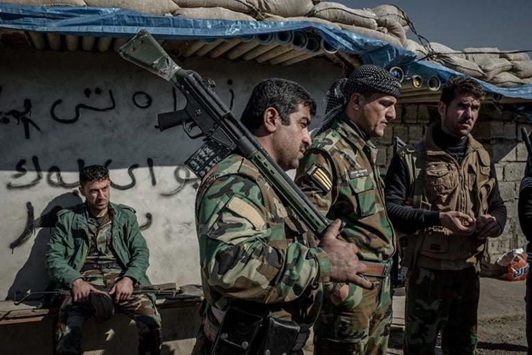 <p>Peshmerga fighters at a frontline southwest of Kirkuk, Iraq. Many Peshmerga fighting ISIS haven’t been paid a salary over four months due to the economic crisis in Kurdistan. (Photograph by Cengiz Yar)</p>
