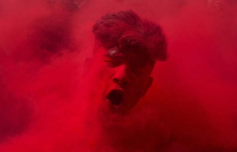 <p>An Indian reveler, face smeared with colored powder, dances during celebrations marking Holi, the Hindu festival of colors, in Gauhati, India. (Anupam Nath/AP)</p>
