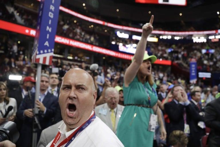 <p>Illinois delegate Christian Gramm, left, and other delegates react as some call for a roll call vote on the adoption of the rules during first day of the Republican National Convention in Cleveland, Monday, July 18, 2016. (AP Photo/John Locher)</p>
