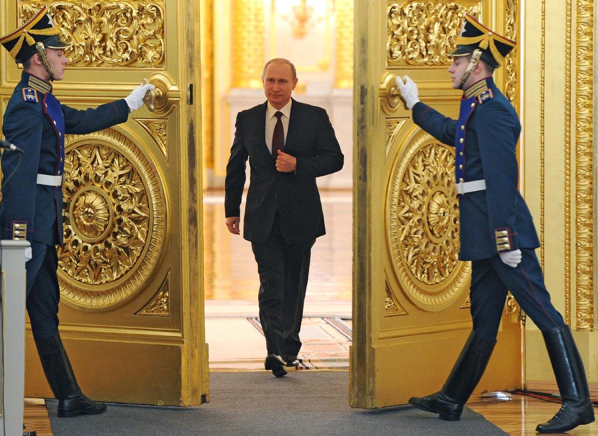 Vladimir Putin enters the St. George Hall at the Grand Kremlin Palace at the Kremlin in Moscow