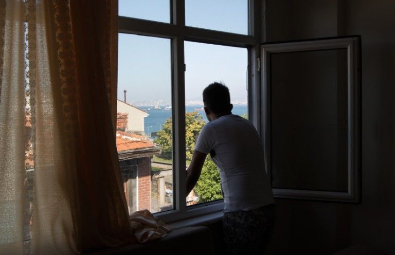 In Istanbul, Turkey, Ahmed Stanekzai (not his real name) looks out over the Marmara sea from his apartment in Istanbul. Since January, Stanekzai has been trying to come to Canada, something he has dreamed about since seeing the video of Prime Minister Justin Trudeau welcoming refugees at Toronto's Pearson International airport in December 2015. The demand to come to Canada has spiked in recent years, far outpacing the Liberal government's refugee quotas. The winners are smugglers and scammers who cash in on people's dreams. (Photograph by Adnan R. Khan)