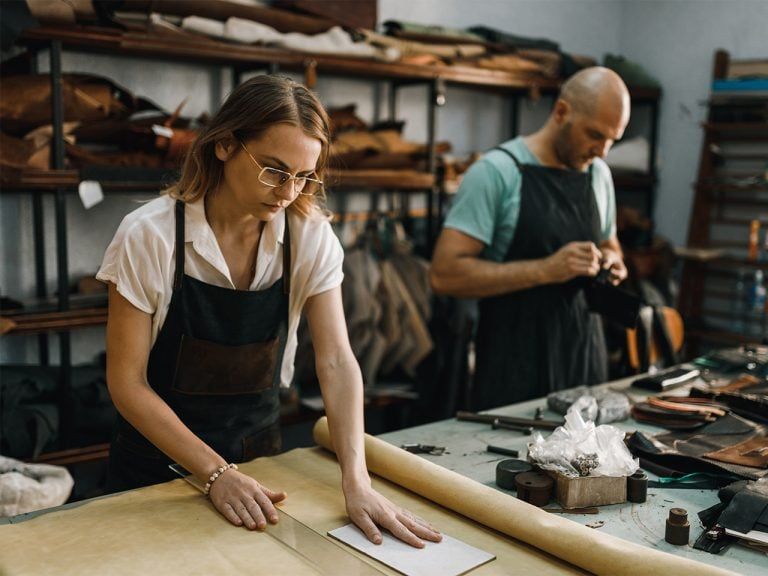 Two people working in a textile workshop