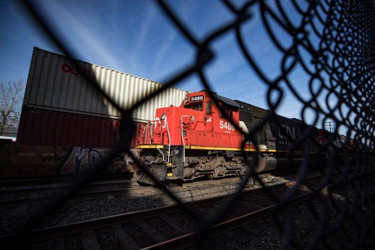 CN Rail locomotives are moved on tracks past cargo containers sitting on idle train cars at port in Vancouver, on Friday, February 21, 2020. Rail blockades across the country have led to an increase in the number of cargo ships waiting to load or unload according to the Port of Vancouver. (Darryl Dyck/CP)