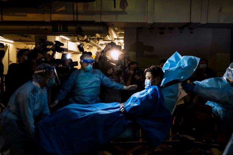 Paramedics transport a man believed to be Hong Kong’s first COVID-19 case, in January (Lam Yik Fei/The New York Times/Redux Pictures)