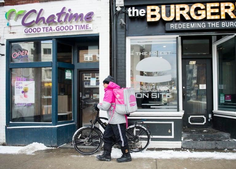 A Foodora courier is pictured as they pick up an order for delivery from a restaurant in Toronto, on Feb. 27, 2020. (Nathan Denette/CP0