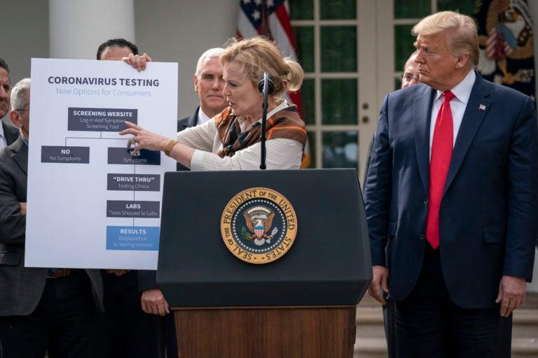 White House Coronavirus Response Coordinator Dr. Deborah Birx holds up a chart outlining testing options at a news conference as Trump looks on. (Drew Angerer/Getty Images)