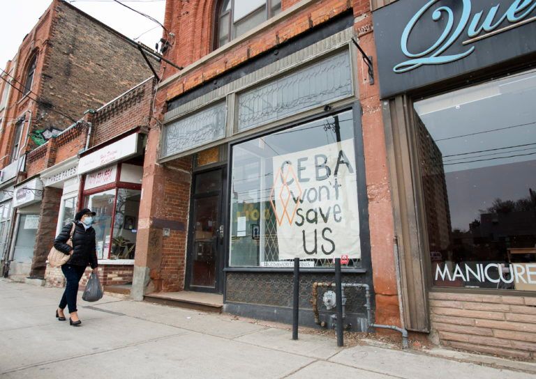 A closed store front in Toronto displays a sign pleading for economic relief, on April 16, 2020 (CP/Nathan Denette)