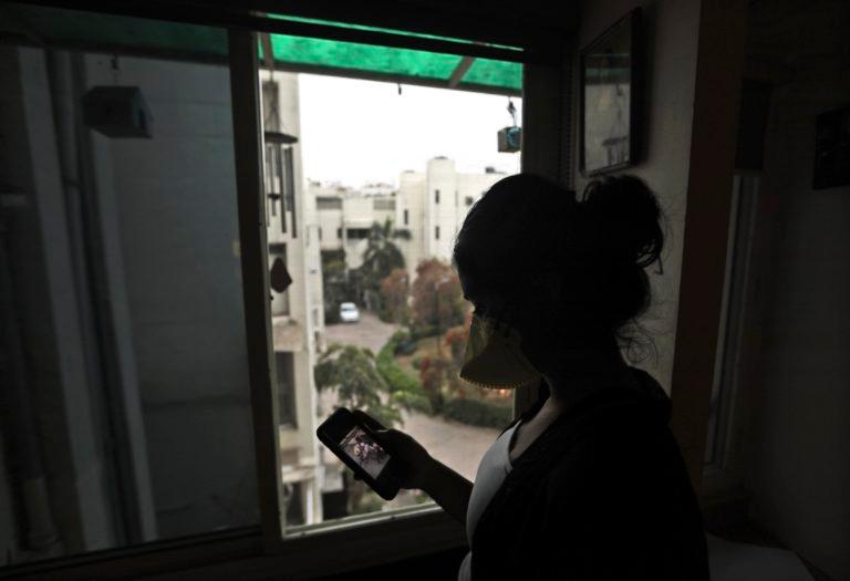 An Indian girl watches a video on the WhatsApp app in New Delhi, India on Mar. 24. With coronavirus starting to spread in the region, social media are rife with bogus remedies, tales of magic cures and potentially hazardous medical advice. (Manish Swarup/AP/CP)