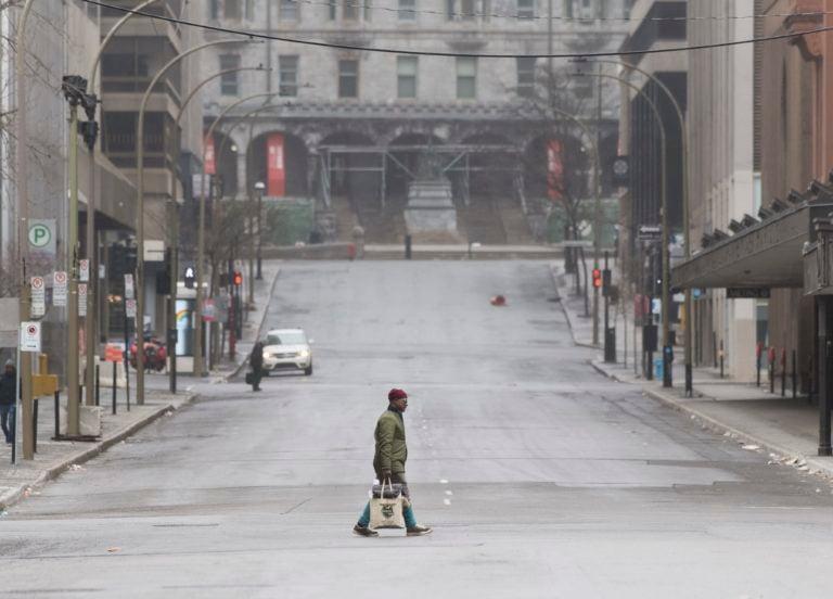 People cross an empty street in downtown Montreal, Sunday, April 5, 2020, as Coronavirus COVID-19 cases rise in Canada and around the world. photo (CP/Graham Hughes)