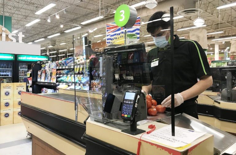 A plexiglass barrier is pictured creating a barrier to protect a cashier at a grocery store in North Vancouver, B.C. Sunday, March 22, 2020. (Jonathan Hayward/CP)