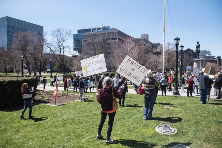 Demonstrators gather during a protest to end the shutdown due to COVID-19 at Queen's Park in Toronto on Saturday, April 25, 2020. (Tijana Martin/CP)
