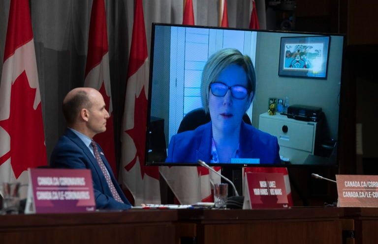 President of the Treasury Board Jean-Yves Duclos looks on as Employment, Workforce Development and Disability Inclusion Minister Carla Qualtrough participates in a daily news conference via video conferencing, Wednesday April 1, 2020 in Ottawa. (Adrian Wyld/CP)