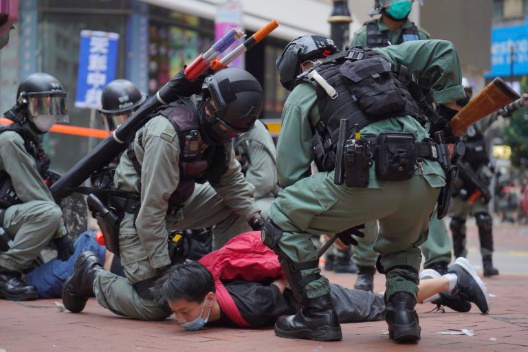 Riot police in Hong Kong detain a protester on Sunday during a demonstration against Beijing's national security legislation (Vincent Yu/AP)