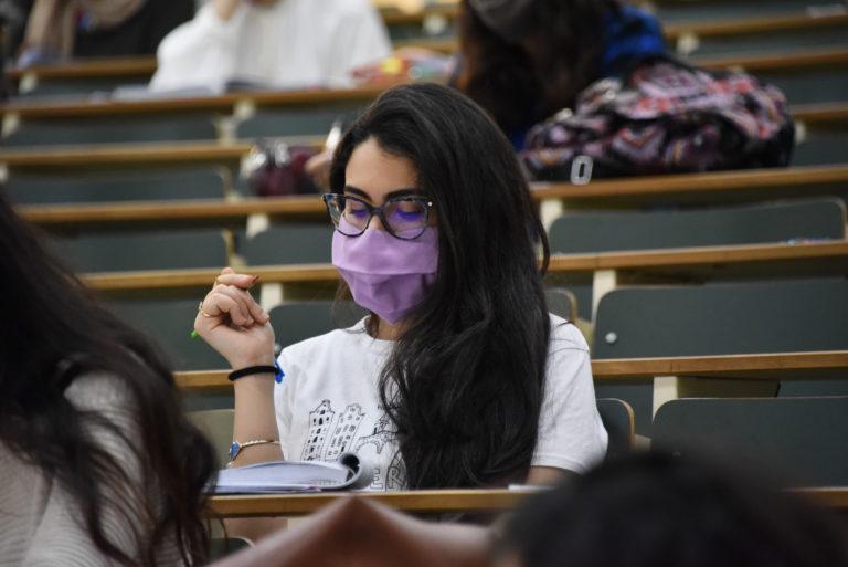 A medical student in Tunis wears a face mask in a lecture hall.