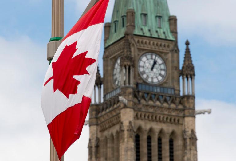 A Canadian flag hangs from a lamp post along the road in front of the Parliament buildings ahead of Canada Day in Ottawa, Tuesday, June 30, 2020. (Adrian Wyld/CP)