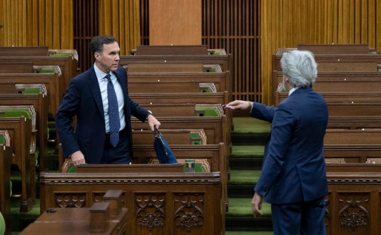 Leader of the Government in the House of Commons Pablo Rodriguez directs Minister of Finance Bill Morneau on where to sit to ensure spacing before a session of the Special Committee on the COVID-19 Pandemic in the House of Commons Wednesday May 13, 2020 in Ottawa. (Adrian Wyld/CP)