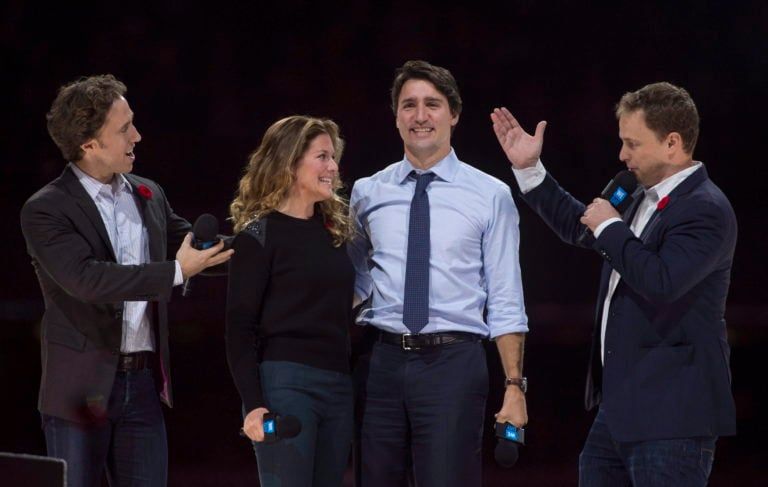 The Kielburger brothers introduce Prime Minister Justin Trudeau and his wife Sophie Gregoire-Trudeau as they appear at the WE Day celebrations in Ottawa in 2015.(Adrian Wyld/CP)
