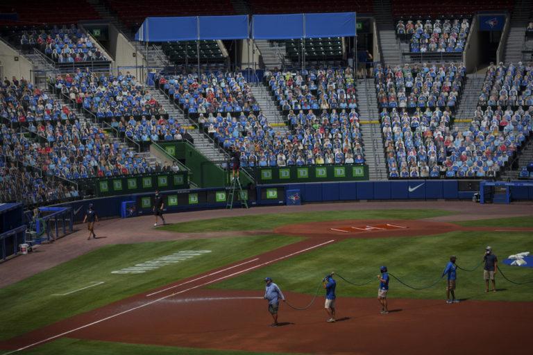 Ground crews prepare Buffalo’s Sahlen Field in front of cardboard Blue Jays fans who paid $60 each for their likenesses to appear in the stands (Michael F. McElroy)