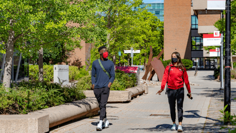 Two students walking on a university campus