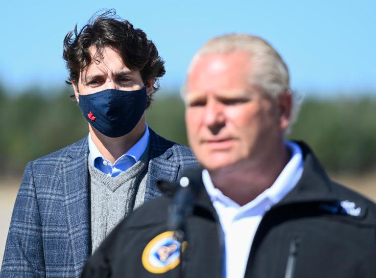 Ontario Premier Doug Ford, right, speaks to the media as Canadian Prime Minister Justin Trudeau listens after taking part in a ground breaking event at the Iamgold Cote Gold mining site in Gogama, Ont., on Friday, September 11, 2020. THE CANADIAN PRESS/Nathan Denette