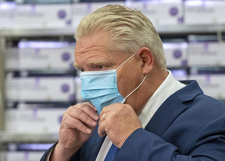 Ontario Premier Doug Ford puts his mask back on during the daily briefing at Humber River Hospital in Toronto on Tuesday November 24, 2020. THE CANADIAN PRESS/Frank Gunn