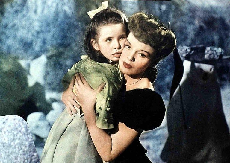 American actor and singer Judy Garland (1922 - 1969) holds Margaret O'Brien in a still from the film, 'Meet Me in St. Louis,' directed by Vincente Minnelli, 1944. (FilmPublicityArchive/United Archives/Getty Images)