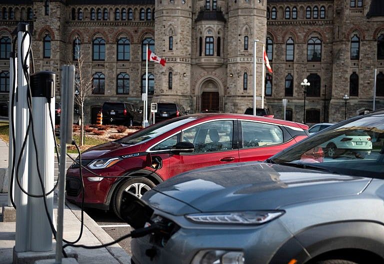 Electric vehicles sit plugged into charging stations outside West Block on Parliament Hill in Ottawa on Thursday, Nov. 19, 2020. (Photograph by Justin Tang)