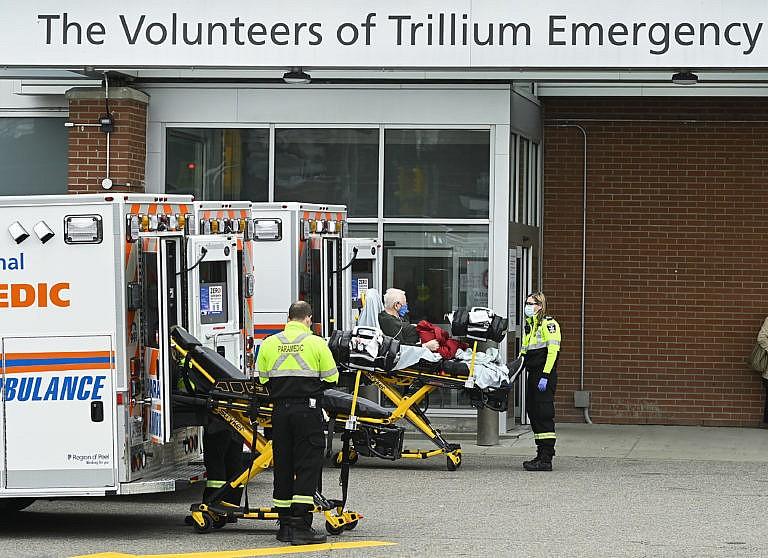 Paramedics transport an elderly man to the hospitals emergency department during the COVID-19 pandemic in Mississauga, Ont., on Thursday, November 19, 2020. Ontario has entered the second wave of coronavirus infections. THE CANADIAN PRESS/Nathan Denette
